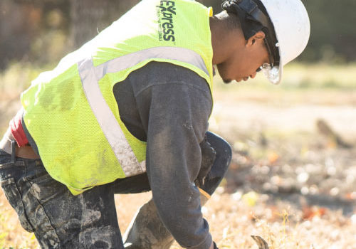Mitigation Resources Employee Wearing Hard Hat & Neon Safety Vest At Job Site